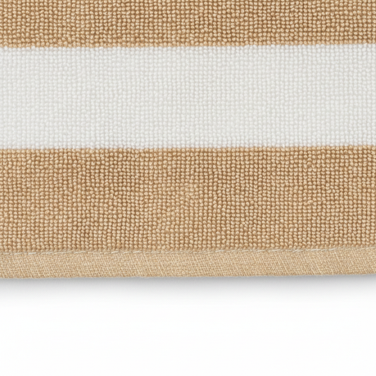 Close-up of striped beach towel fabric texture in beige and white