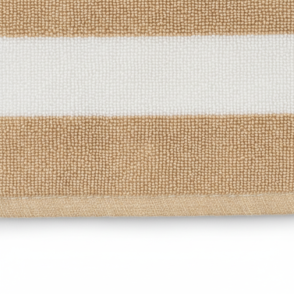 Close-up of striped beach towel fabric texture in beige and white
